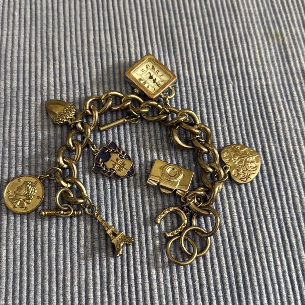 charm bracelet .silver tone , 8” long.10 pcs different charm